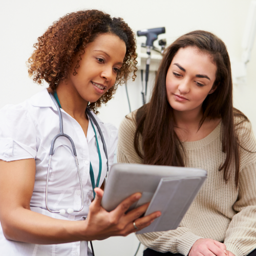 female nurse assisting female patient