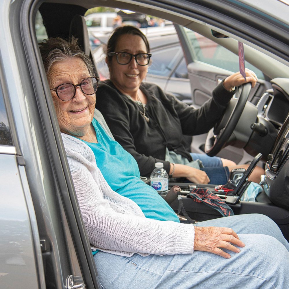 two women in car looking at camera